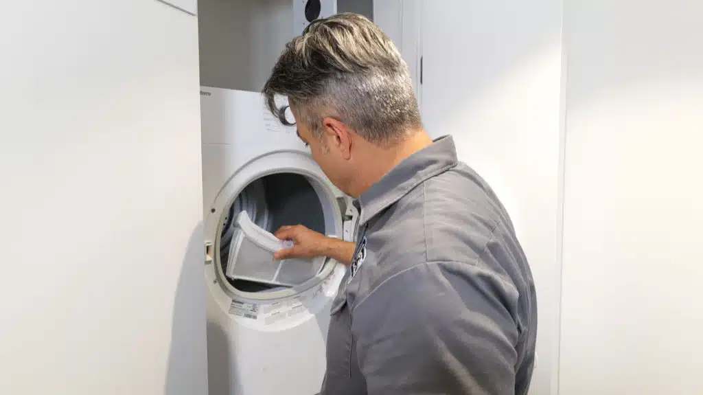 repairman is repairing washing machine